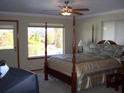 528 South Hennessy Road Yakima, WA 98908 - Photo 20 of 26 a bedroom with a bed ceiling fan and a window