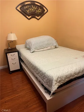 a bedroom with a bed and dresser