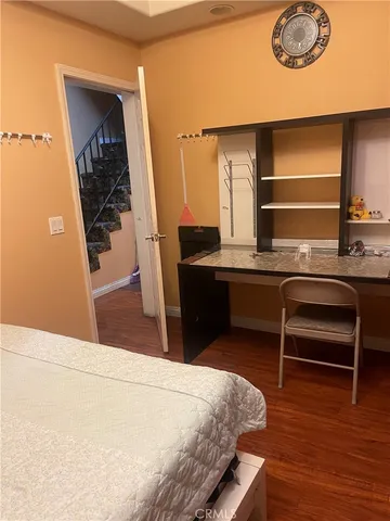a bedroom with a bed and a dresser