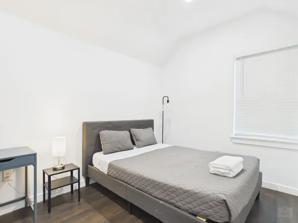 a bedroom with a bed and a night stand