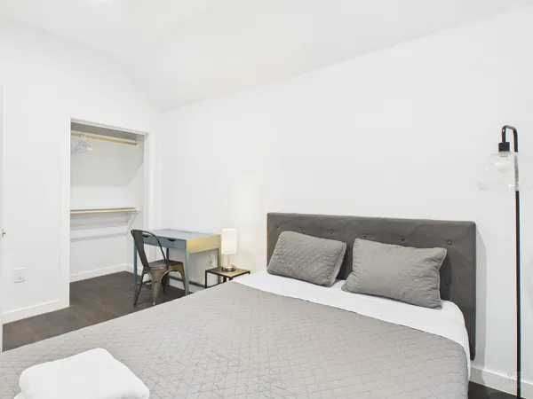 a bedroom with a bed and a chair