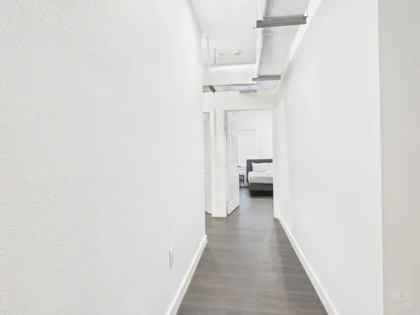 a hallway with a white cabinet