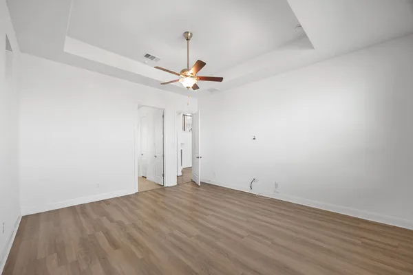 a spacious bathroom with a bathtub sink and mirror