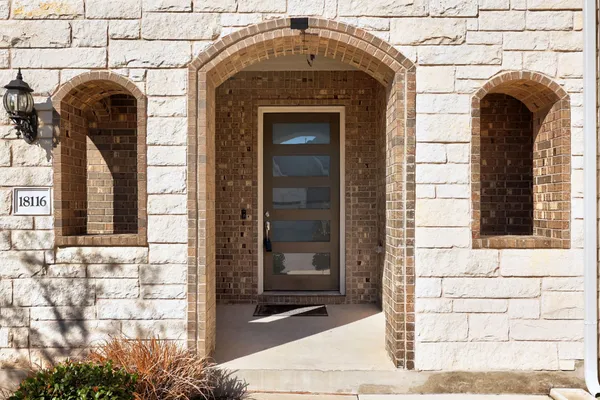 a front view of a house with a garden
