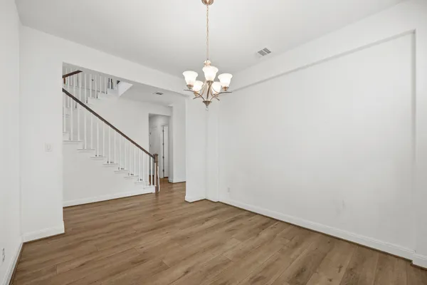 a view of a chandelier fan and wooden floor