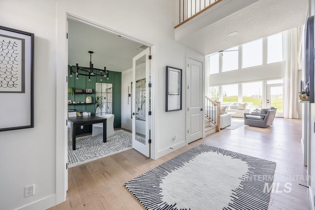 7385 West Flathead Lk Street Eagle, ID 83616 - Photo 4 of 14 Foyer featuring a high ceiling, light wood finished floors, and stairs
