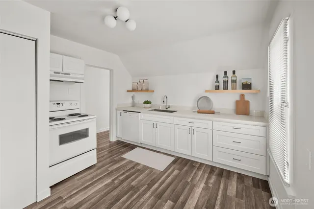 a kitchen with white cabinets and white appliances