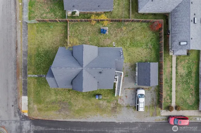 an aerial view of a house with a yard