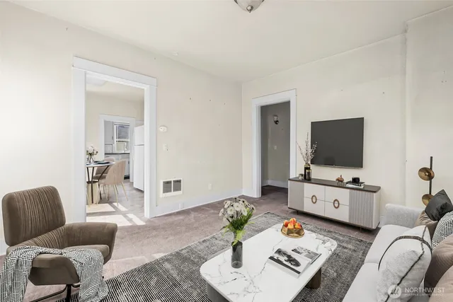 a living room with furniture and a flat screen tv