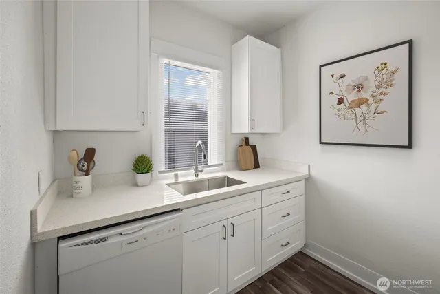 a view with cabinets a sink and a window