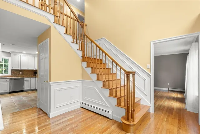a view of entryway and hall with wooden floor