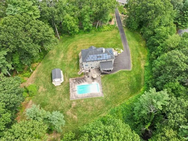 a aerial view of a house with a yard