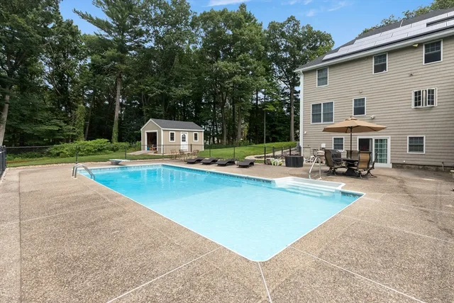 a view of a house with swimming pool and sitting area