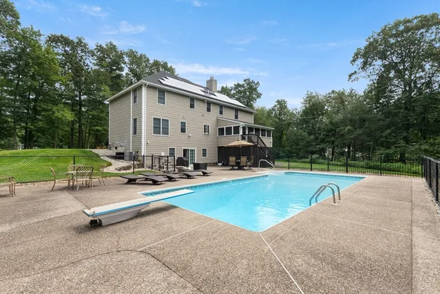 a view of a house with swimming pool and a yard
