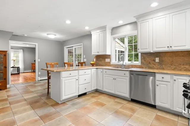 a kitchen with a sink window and cabinets