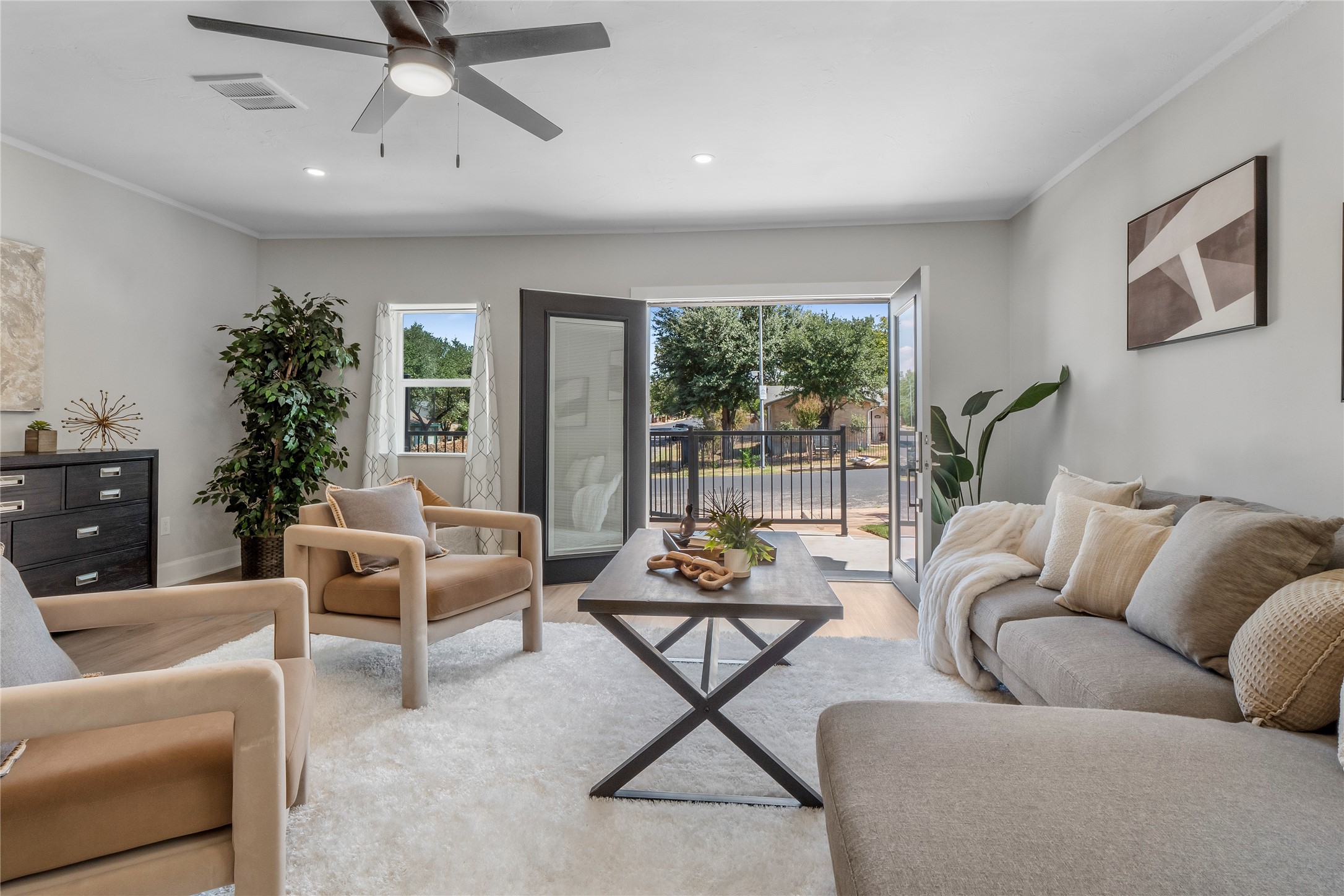8007 Colony Loop Drive Austin, TX 78724 - Photo 12 of 40 Bright living space with recessed lighting and French doors opening directly to the frontyard for effortless indoor-outdoor living.
