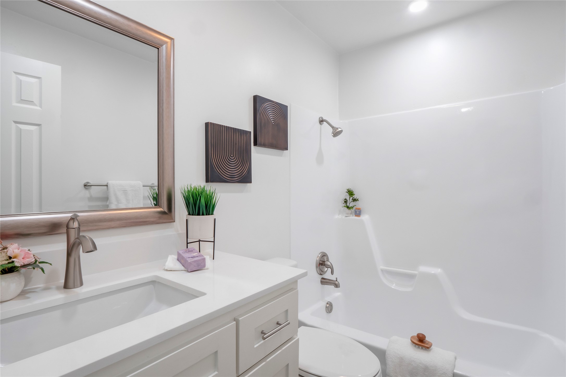 8007 Colony Loop Drive Austin, TX 78724 - Photo 21 of 40 Updated secondary bath with quartz vanity, brushed-nickel fixtures, and a clean tub-shower surround.