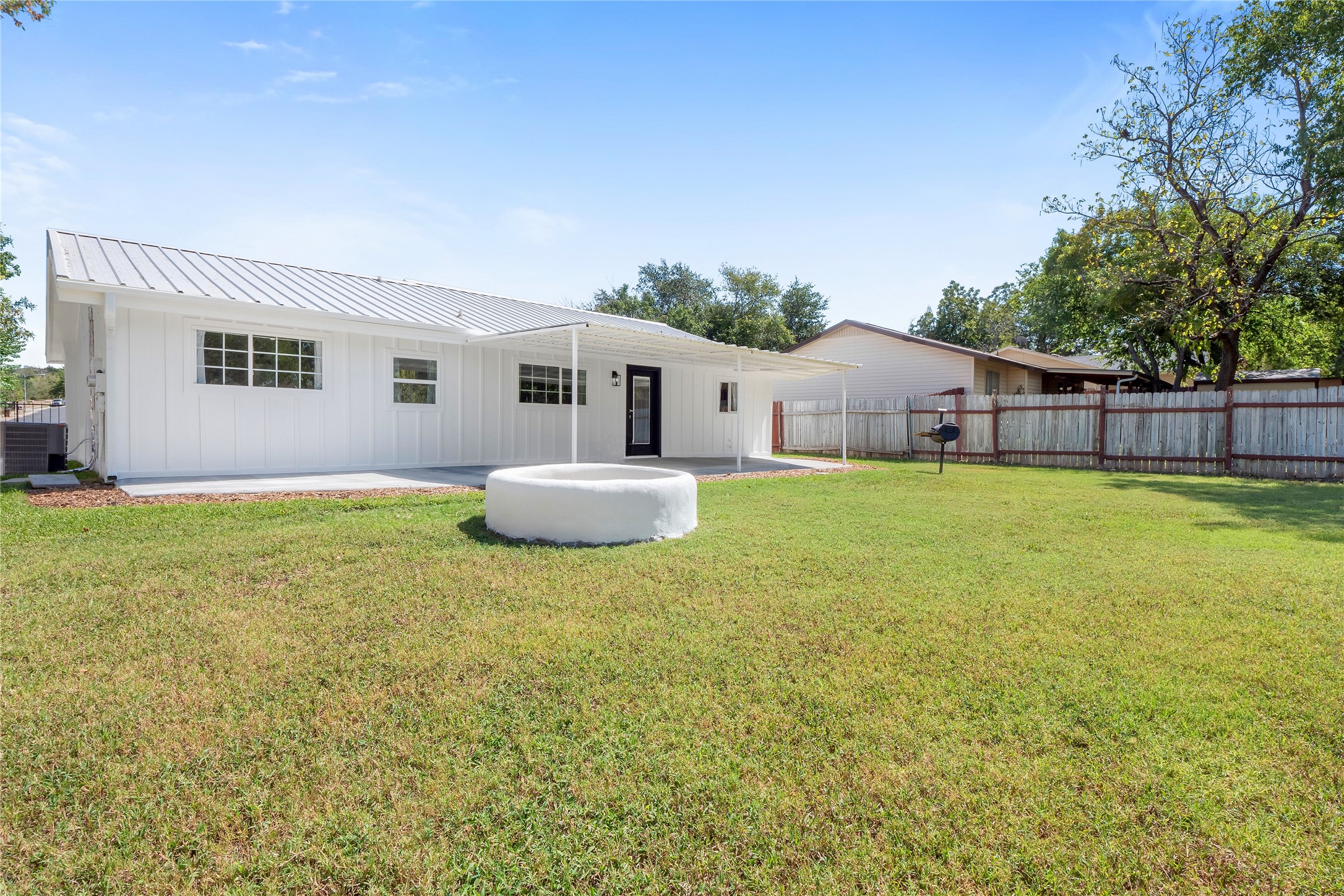 8007 Colony Loop Drive Austin, TX 78724 - Photo 31 of 40 Large backyard with covered patio, open lawn, and built-in fire pit designed for entertaining and everyday outdoor living.