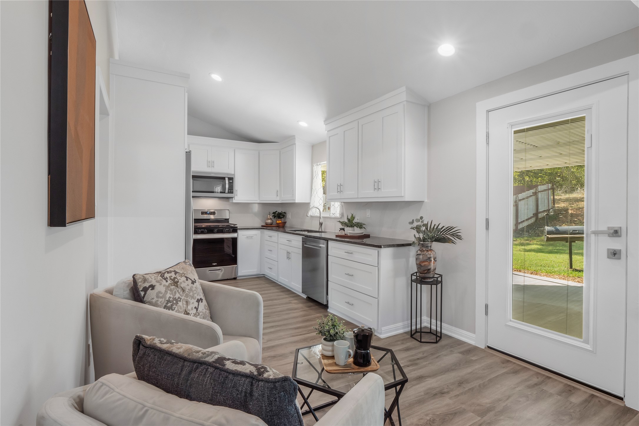 8007 Colony Loop Drive Austin, TX 78724 - Photo 6 of 40 Open-concept layout connecting kitchen and living spaces with direct access to the backyard for easy indoor-outdoor living.