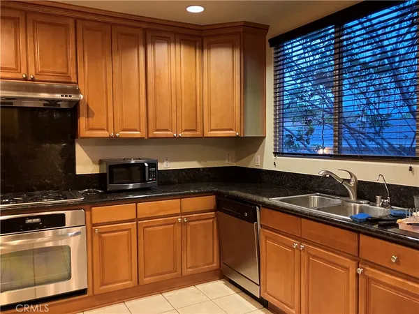 an empty room with wooden floor and mirror