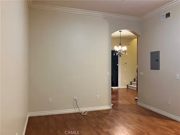 a view of an empty room with closet and a window