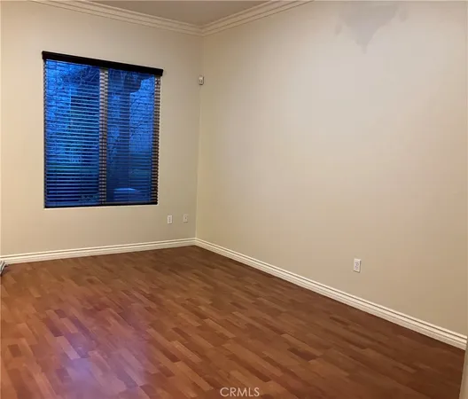 a view of a room with wooden floor and chandelier