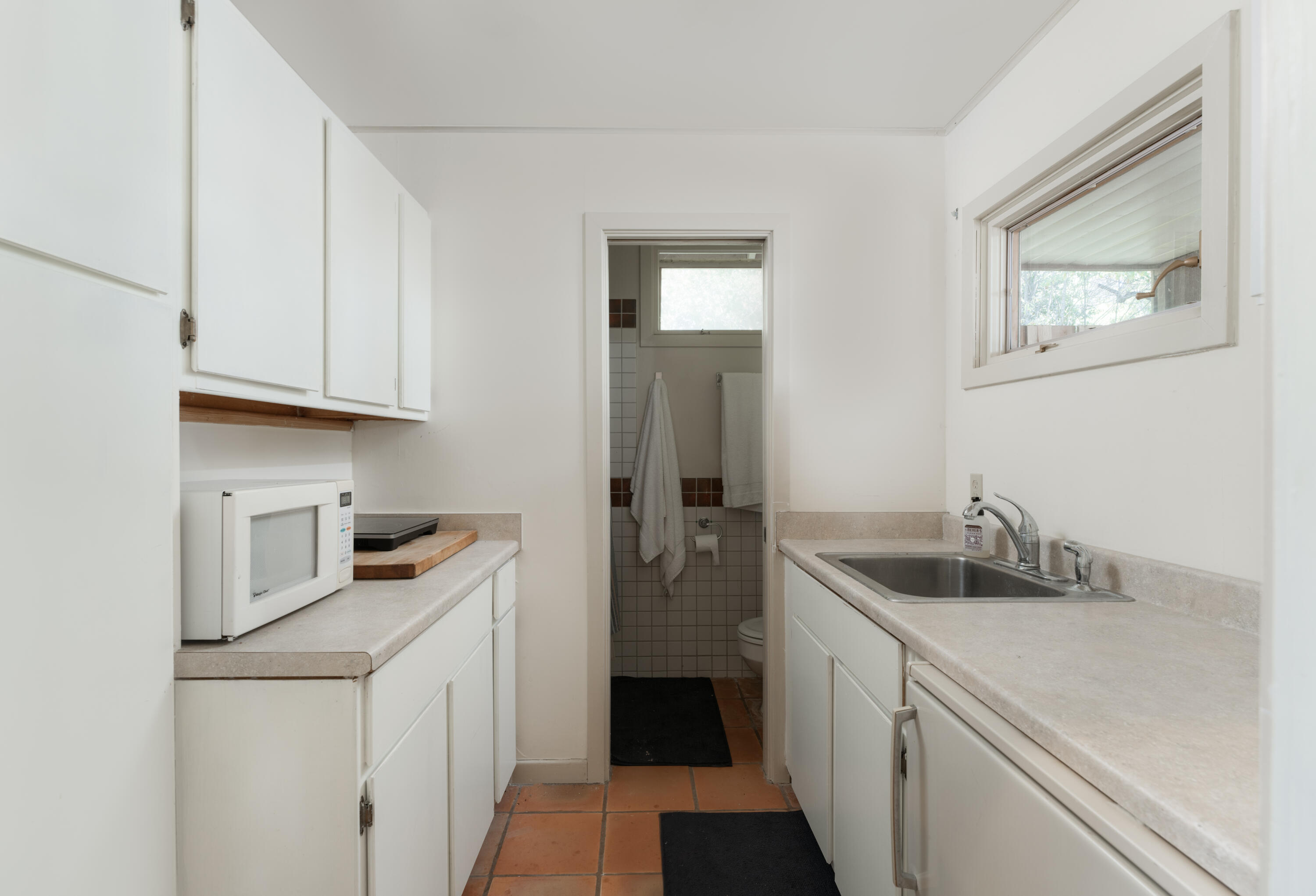 690 San Ysidro Road Montecito, CA 93108 - Photo 28 of 34 a kitchen with a sink and cabinets