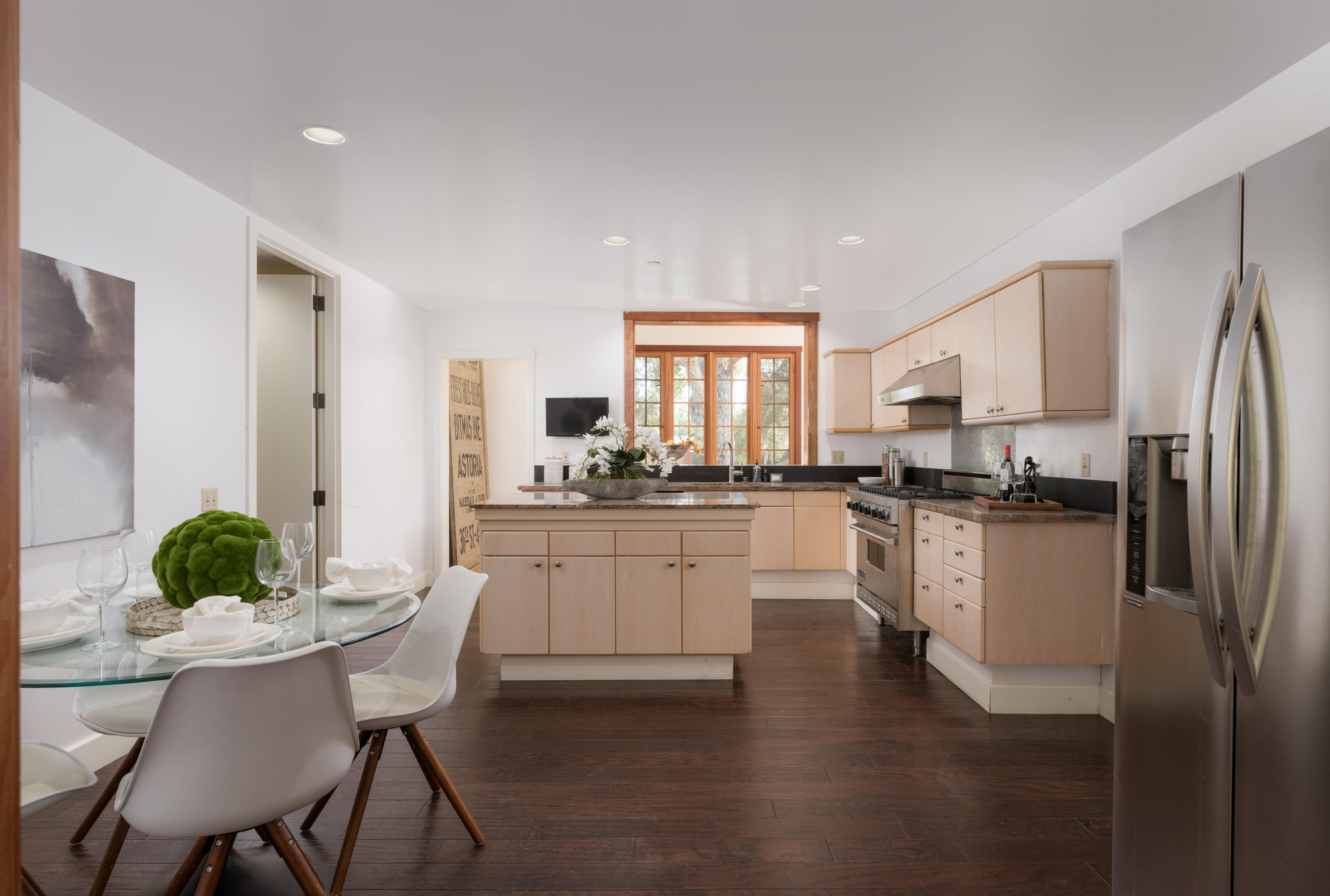 690 San Ysidro Road Montecito, CA 93108 - Photo 8 of 34 a kitchen with a refrigerator and white cabinets
