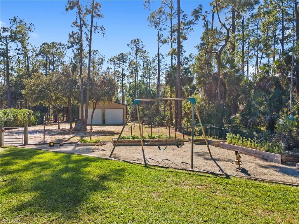 220 18th Avenue Northwest Naples, FL 34120 - Photo 14 of 18 a view of a park with swings