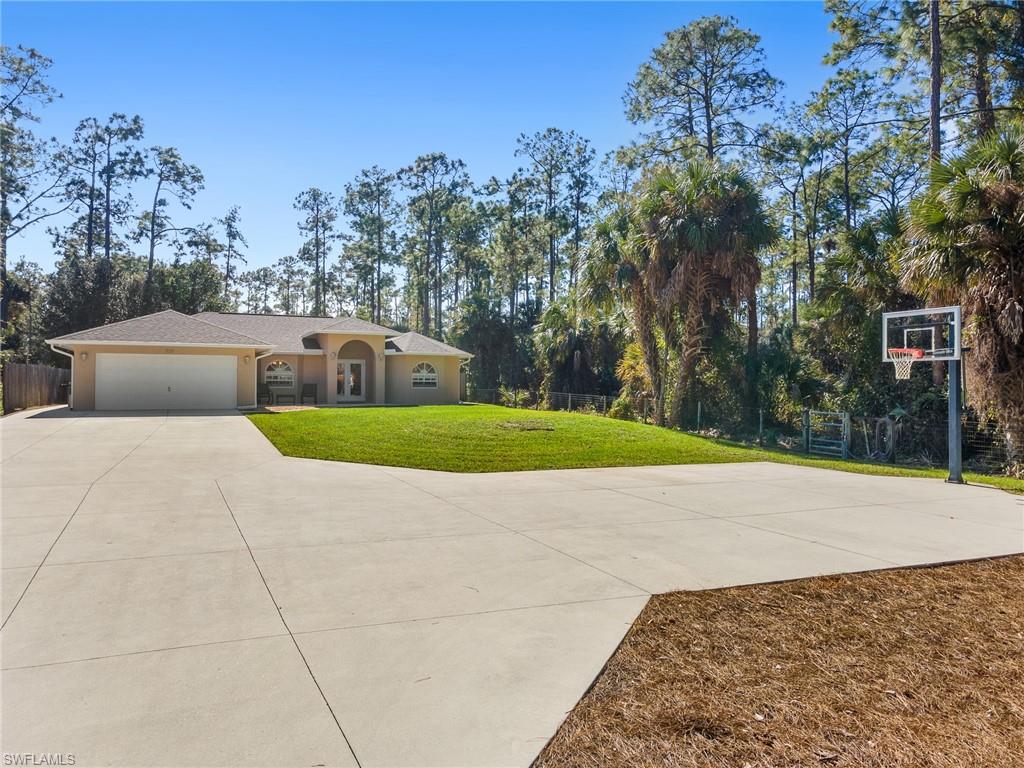 220 18th Avenue Northwest Naples, FL 34120 - Photo 2 of 18 a view of backyard with swimming pool and seating area