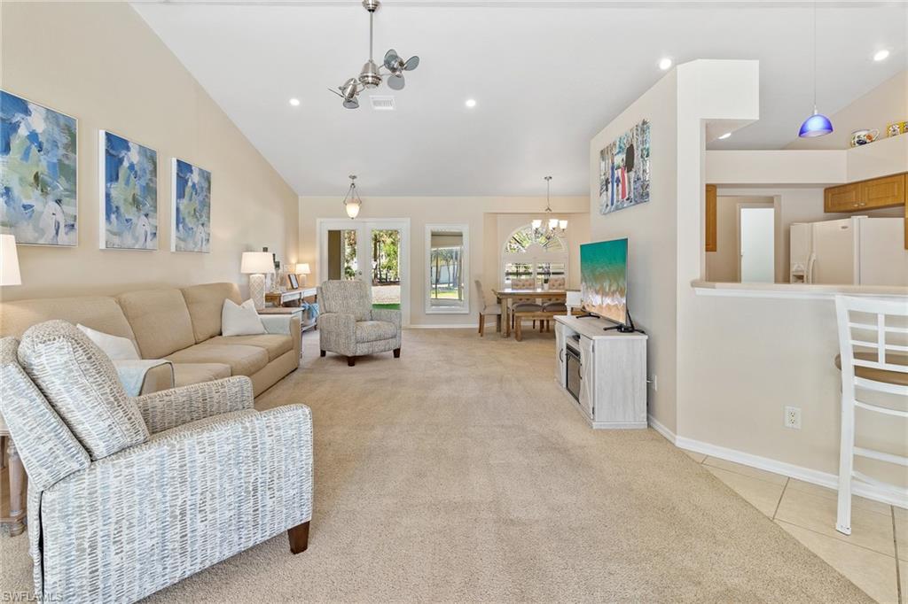 220 18th Avenue Northwest Naples, FL 34120 - Photo 5 of 18 a living room with furniture and a chandelier