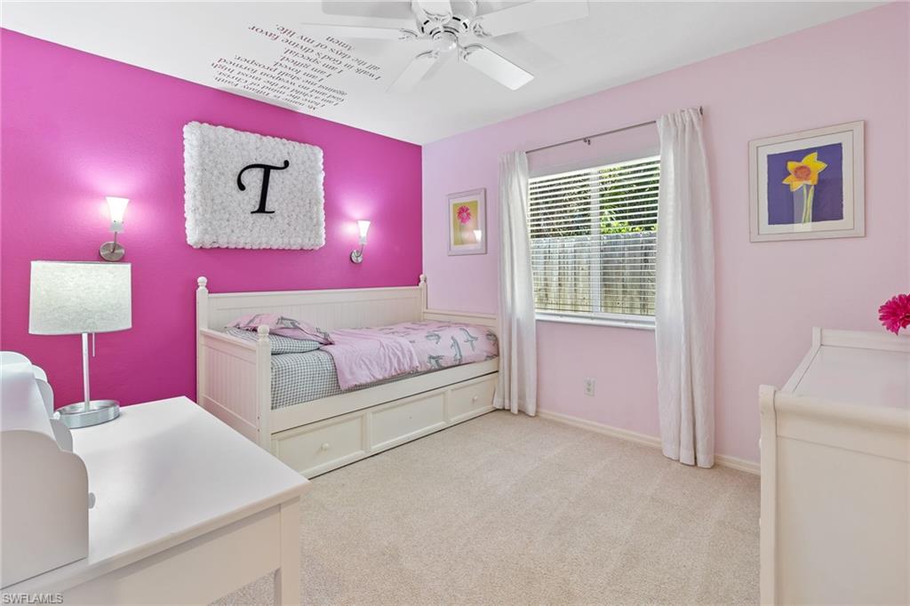 220 18th Avenue Northwest Naples, FL 34120 - Photo 10 of 18 a spacious bedroom with a bed and a chandelier