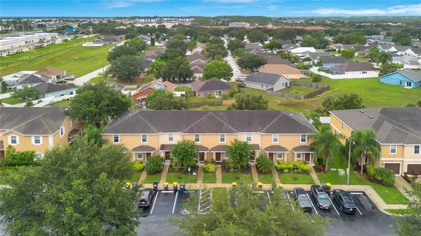 an aerial view of residential houses with outdoor space and street view
