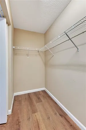 a view of a room with wooden floor
