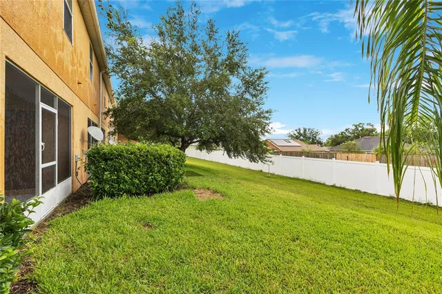 a view of yard with large trees