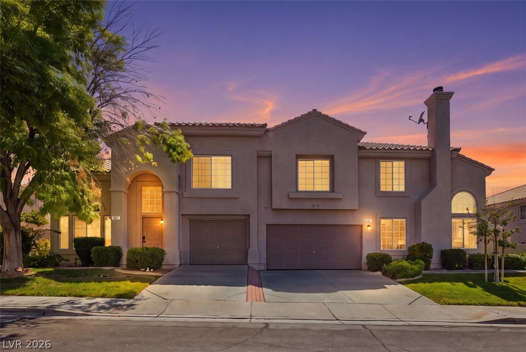 505 Rafkin Place Henderson, NV 89052 - Photo 3 of 35 An inviting exterior and manicured landscaping under a vibrant twilight sky.