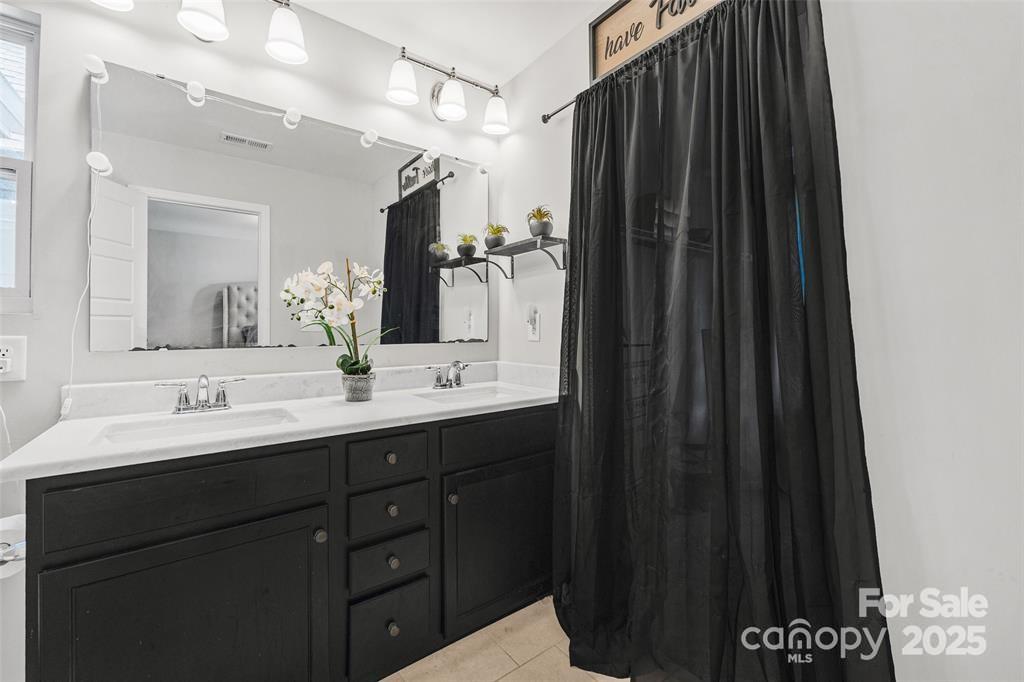 1117 Streamside Lane York, SC 29745 - Photo 14 of 21 a bathroom with a double vanity sink and mirror