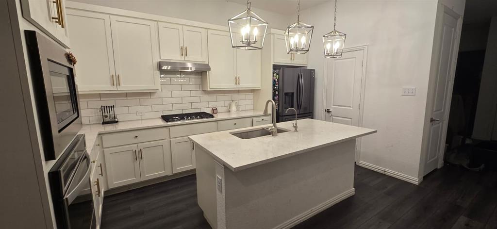9807 Romo Street Irving, TX 75063 - Photo 5 of 8 a kitchen with stainless steel appliances a sink stove and refrigerator
