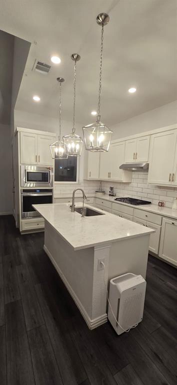 9807 Romo Street Irving, TX 75063 - Photo 8 of 8 a kitchen with stainless steel appliances granite countertop a stove a refrigerator and a wooden floor