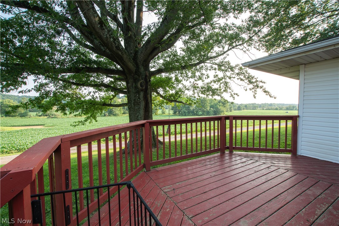 1757 Pleasant Valley Road Northeast New Philadelphia, OH 44663 - Photo 11 of 33 Spacious outdoor deck with deep red wood-finish flooring and matching railings
