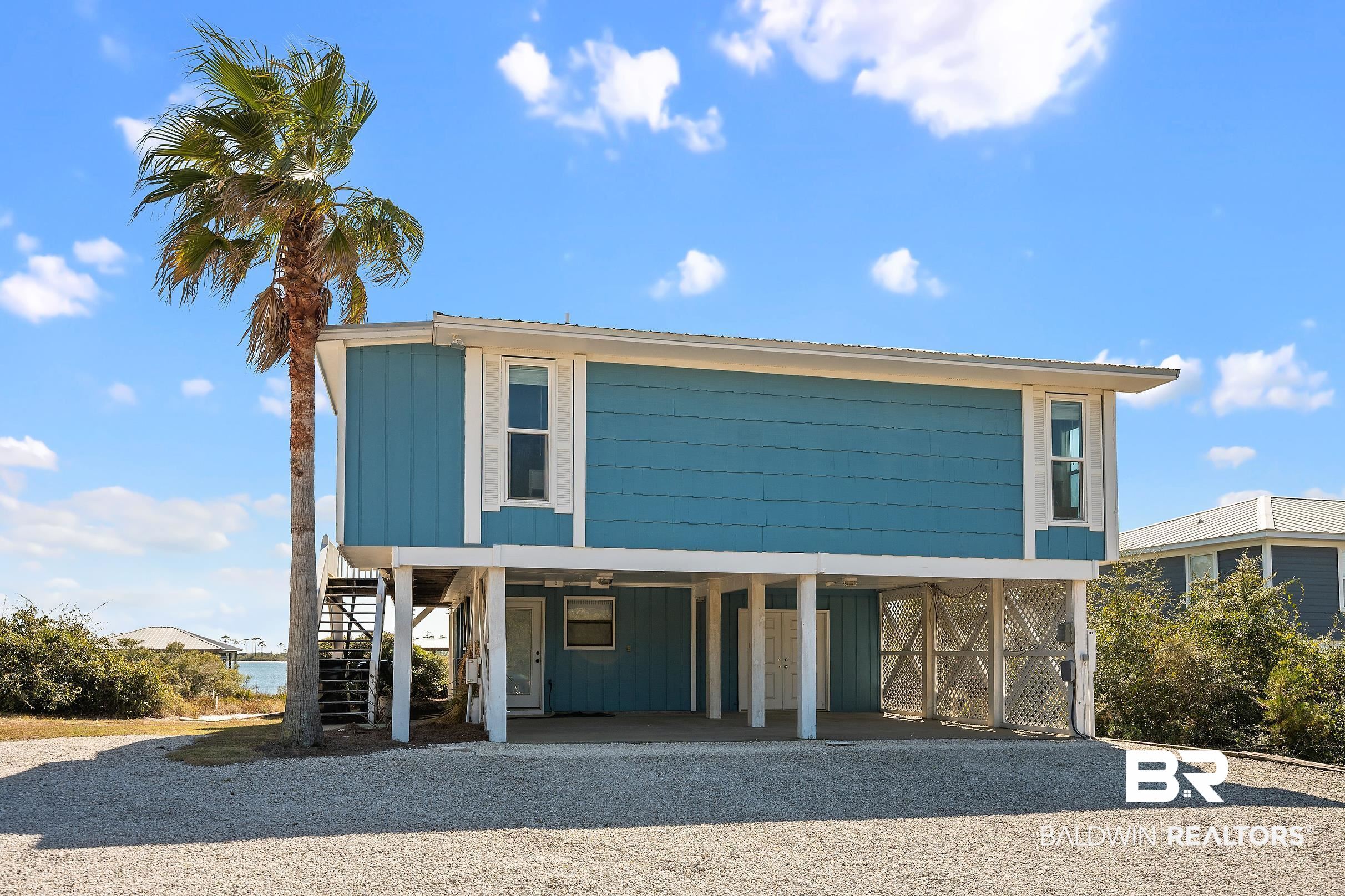 32620 River Road Orange Beach, AL 36561 - Photo 4 of 60 Beach home with a carport, a patio, and gravel driveway