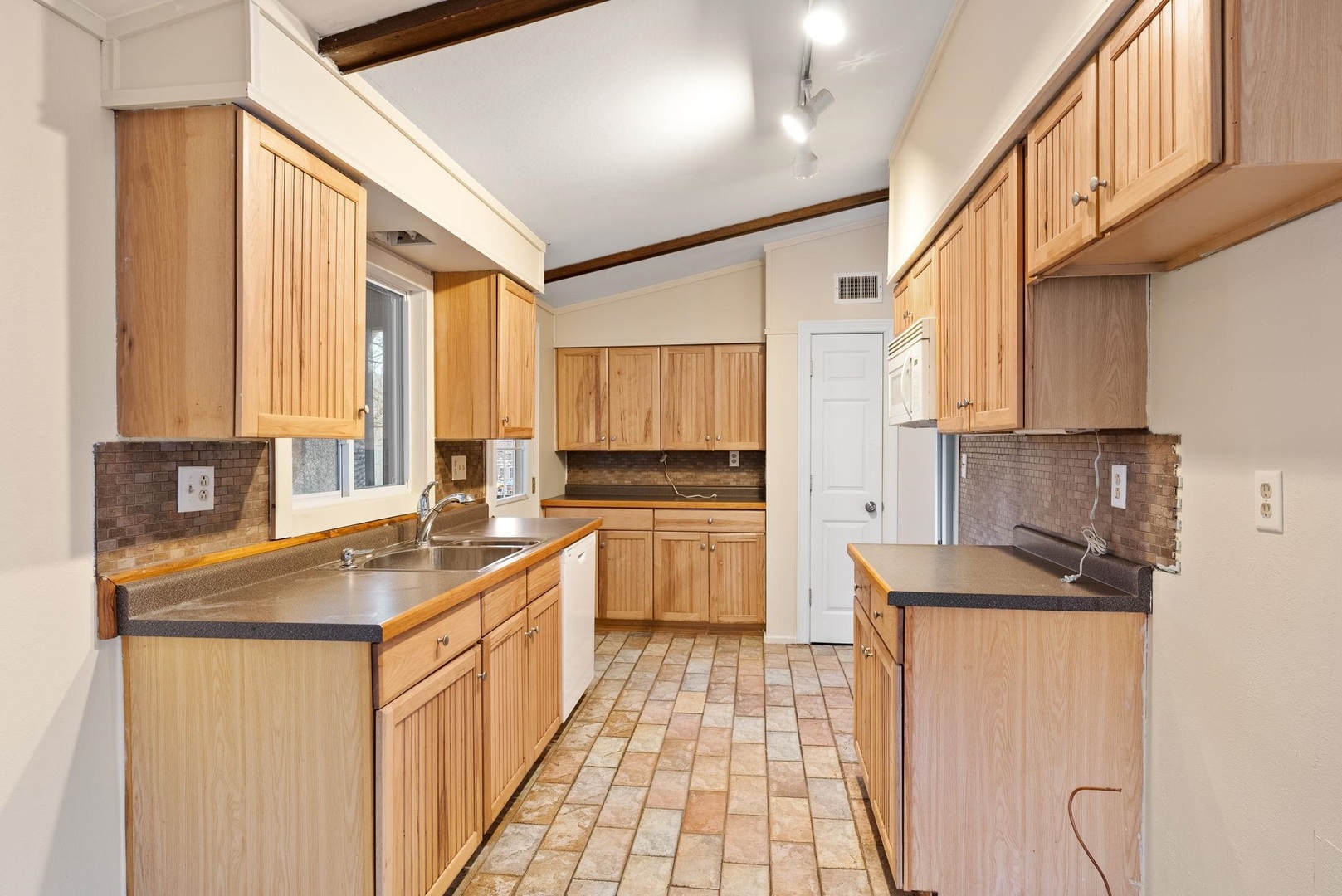 1920 River Vista Road Muscatine, IA 52761 - Photo 15 of 24 a kitchen with stainless steel appliances granite countertop a sink stove and refrigerator