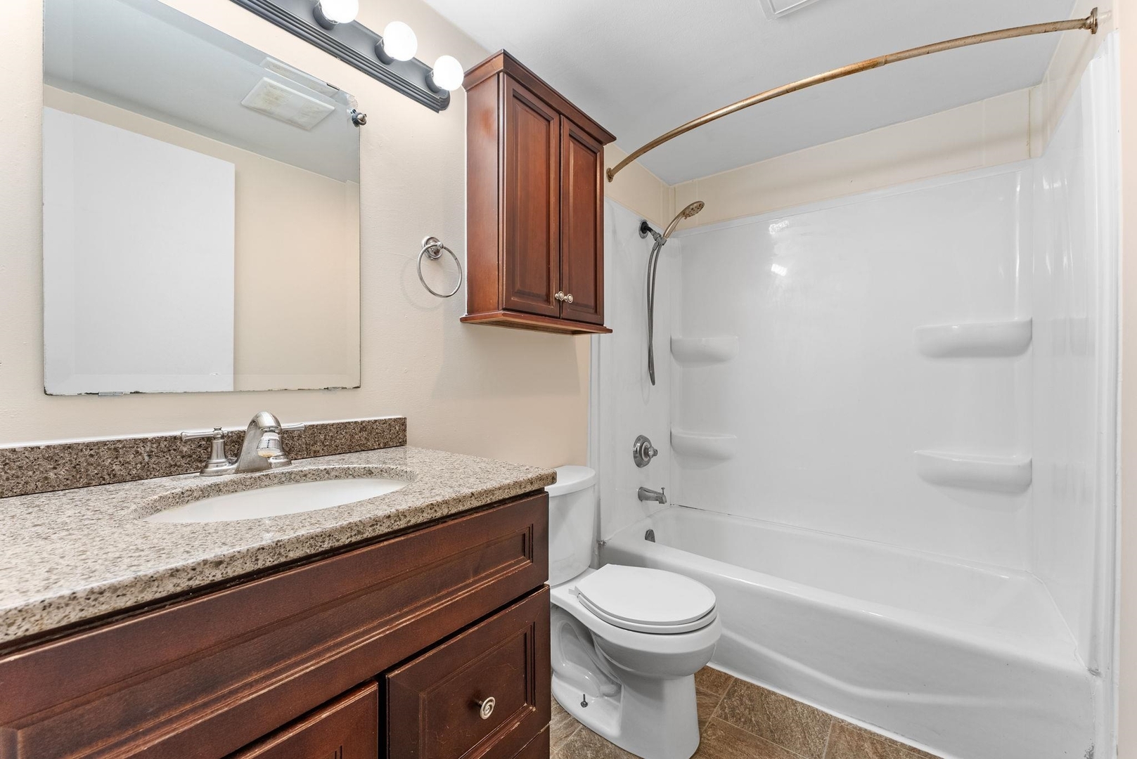 1920 River Vista Road Muscatine, IA 52761 - Photo 17 of 24 a bathroom with a granite countertop sink a toilet and shower