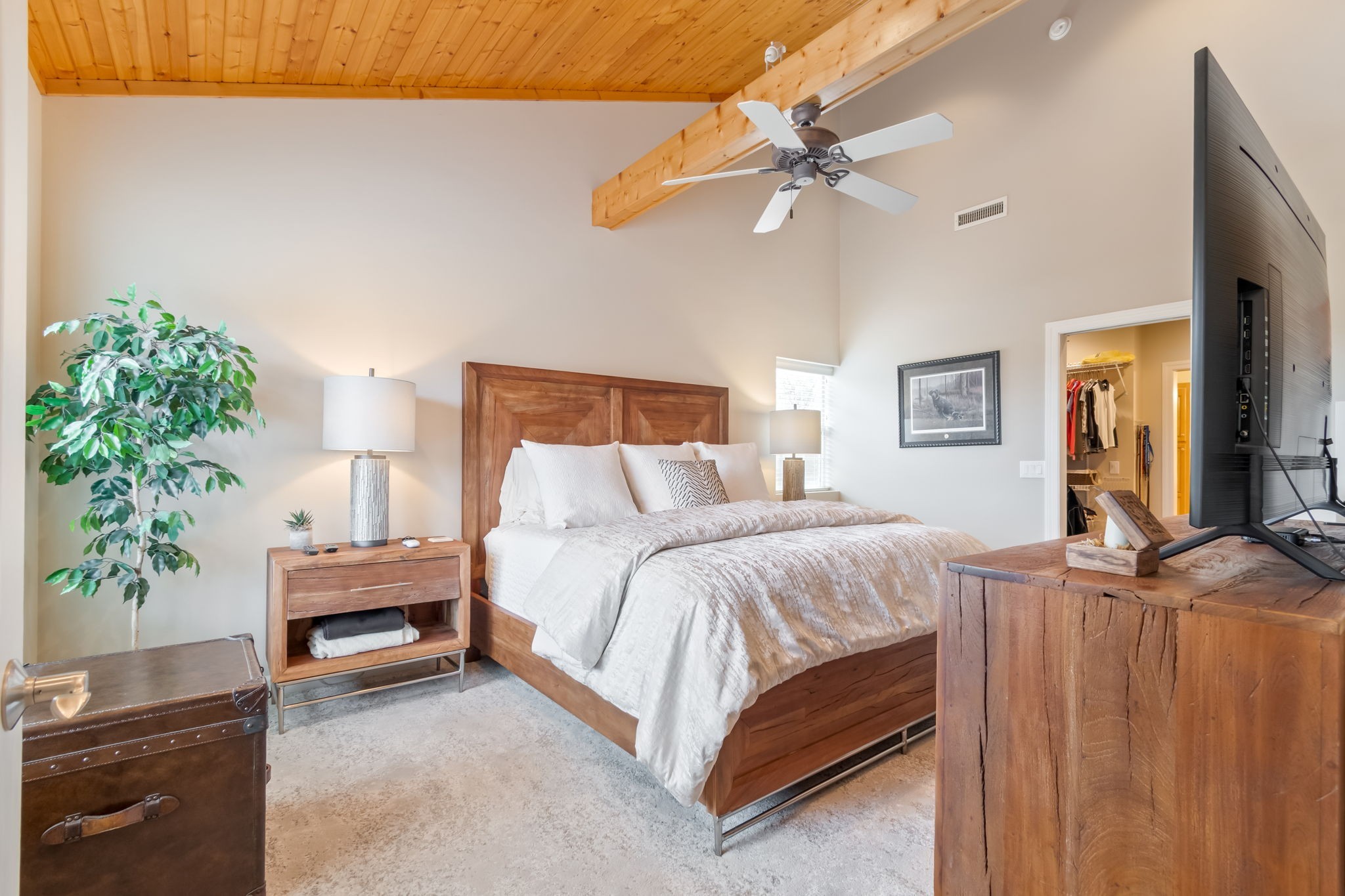 3100 Floyd Road Eagleville, TN 37060 - Photo 45 of 62 a bedroom with a bed table flowerpot and a potted plant