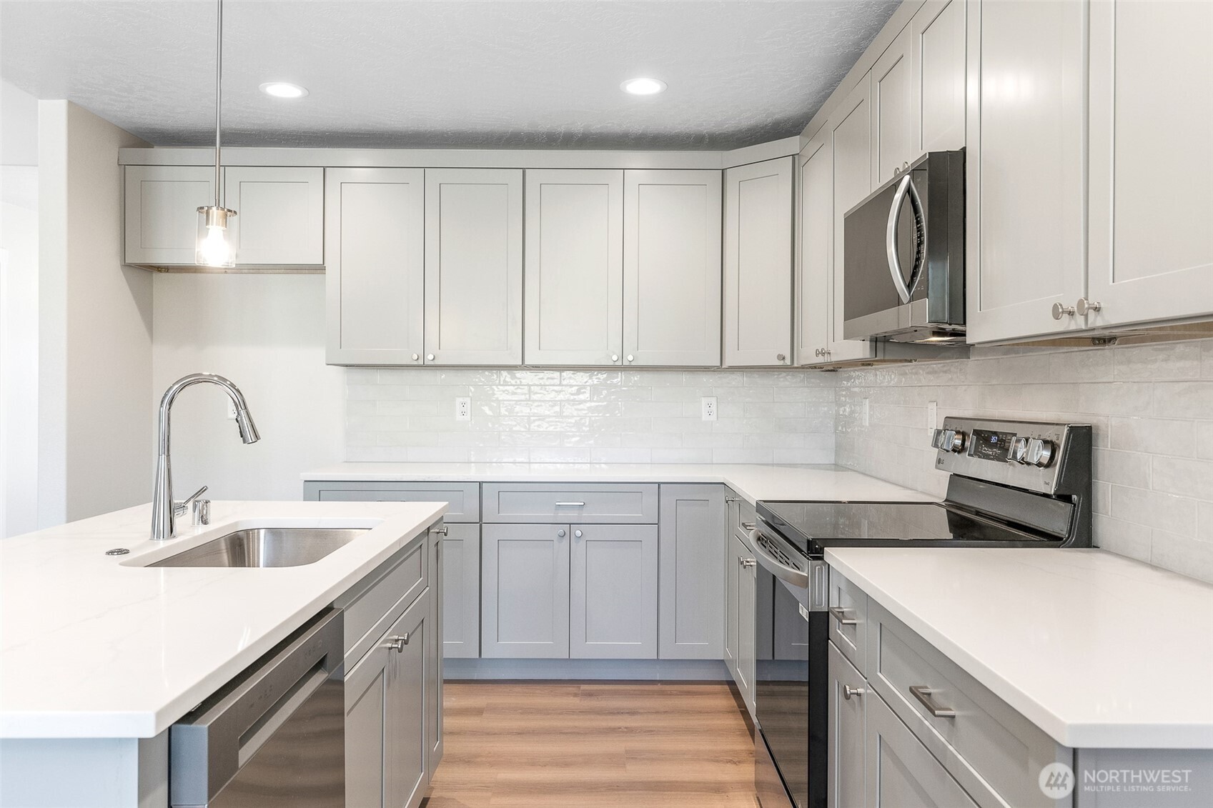 4246 Sandy Street Moses Lake, WA 98837 - Photo 11 of 29 a kitchen with a sink stove and cabinets