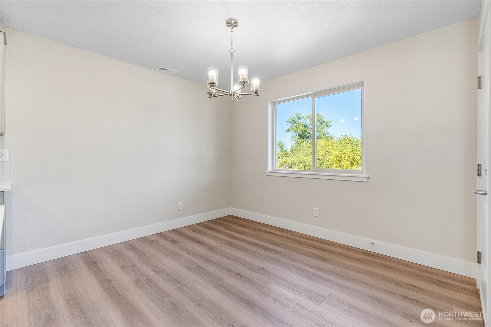 4246 Sandy Street Moses Lake, WA 98837 - Photo 13 of 29 wooden floor in an empty room with a window