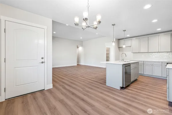 a view of kitchen with granite countertop cabinets and wooden floor