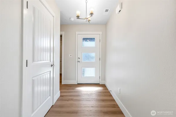 a view of a hallway with wooden floor