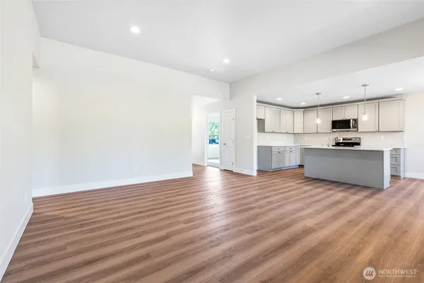 a view of kitchen with wooden floor and electronic appliances