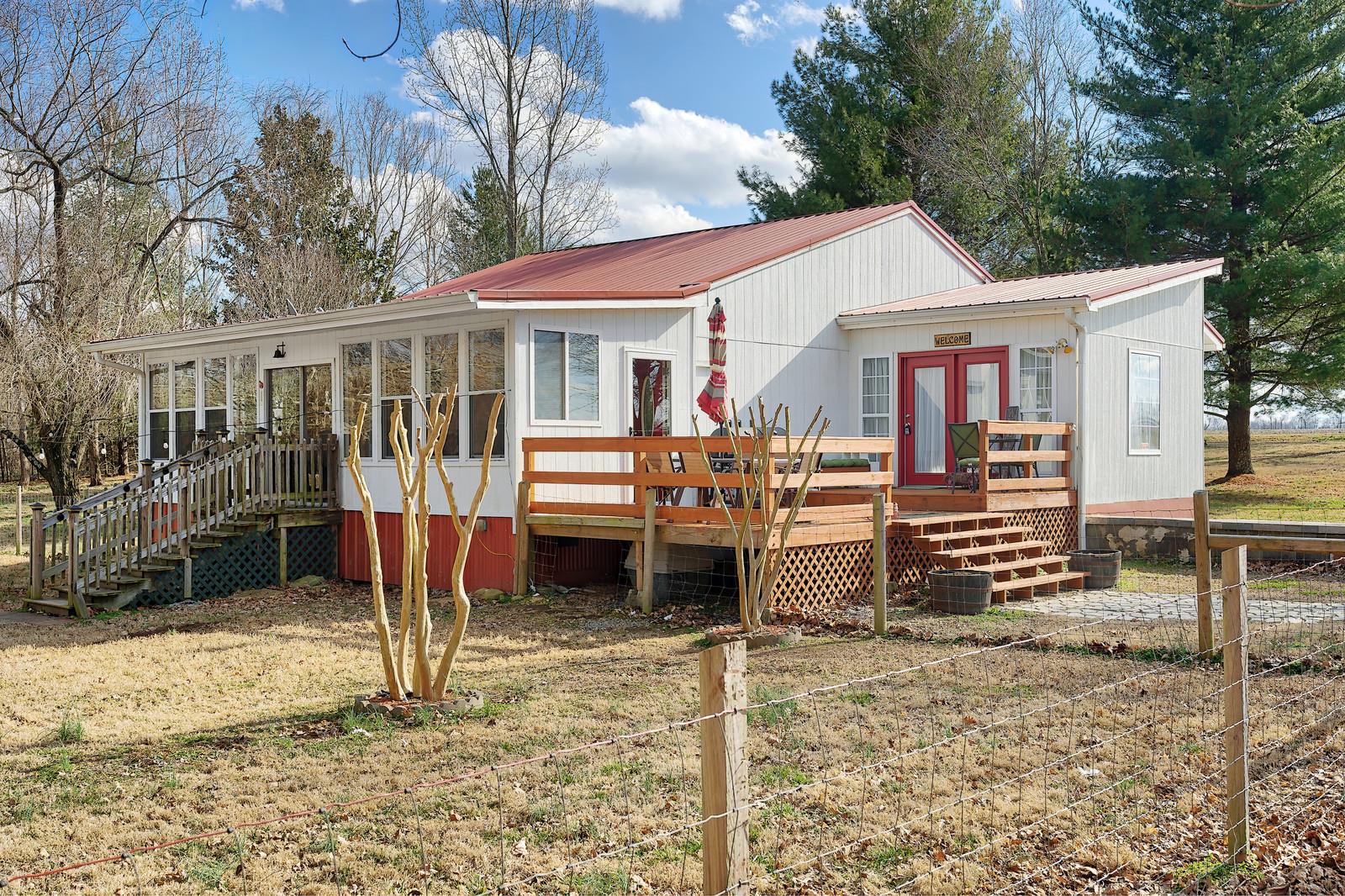 2958 Kinneys Road Cedar Hill, TN 37032 - Photo 1 of 30 a backyard of a house with barbeque oven table and chairs